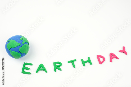 Globe ,earth made from clay and letter earth day on white background.Concept Save green planet. Earth day holiday concept