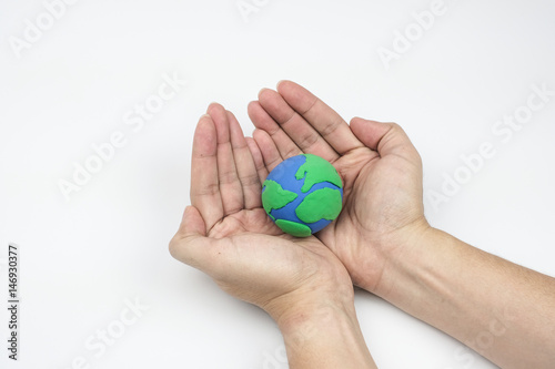 Globe ,earth made from clay in hand on white background. Concept Save green planet. Earth day holiday concept