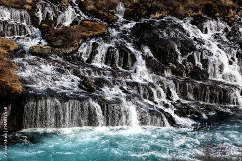 Hraunfossar in western Iceland is a series of waterfalls formed by rivulets streaming out of the Hallmundarhraun lava field.