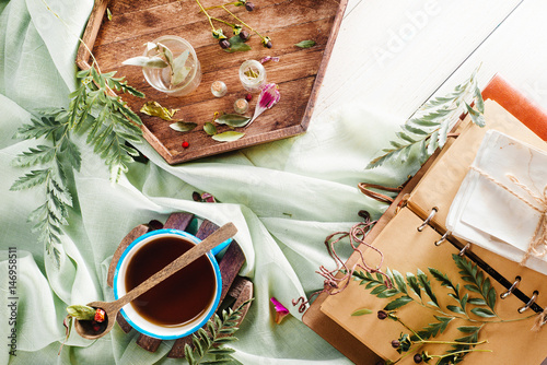 Botanical still life with tea and petals photo