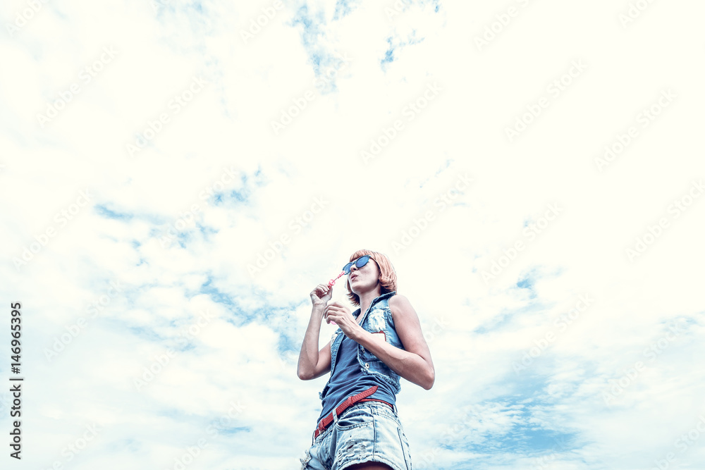Beautiful young woman blowing bubble in outdoor, nature, near the ocean. Tropical magic island Bali, Indonesia. Beautiful young woman blowing bubble in outdoor, nature, near the ocean. Tropical magic island Bali, Indonesia.