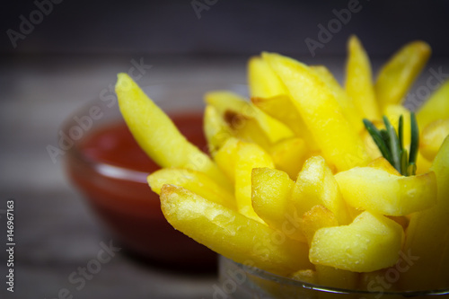 Potato with ketchup on wooden background