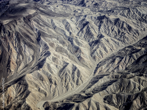 Wood grain texture background in brown black knots