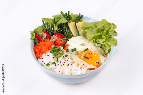 Thai jasmine rice topped soft boil eggs and fried herb.