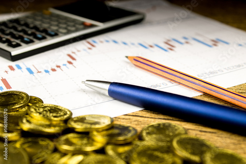 calculator,pencil and money on graffica the Dow Jones photo