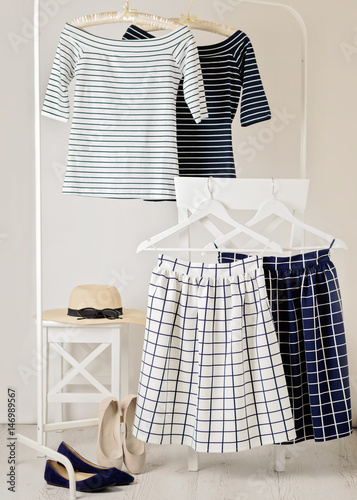 Fashion trend stripes. White and blue striped tops, blue and white skirts in cell.
