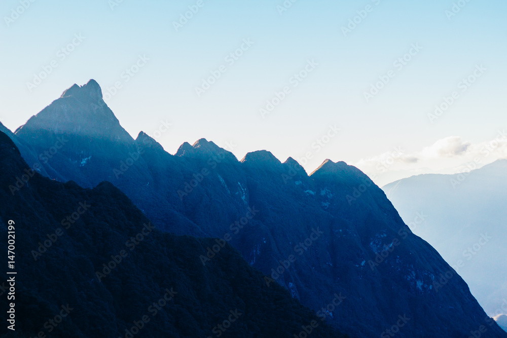 Fototapeta premium Colourful sunshine on a landscape of beautiful Fan Si Pan (Fansipan) or Phan Xi Pang mountain, the highest mountain in Indochina in Sapa, Hoang Lien National Park, Lao cai province northern Vietnam