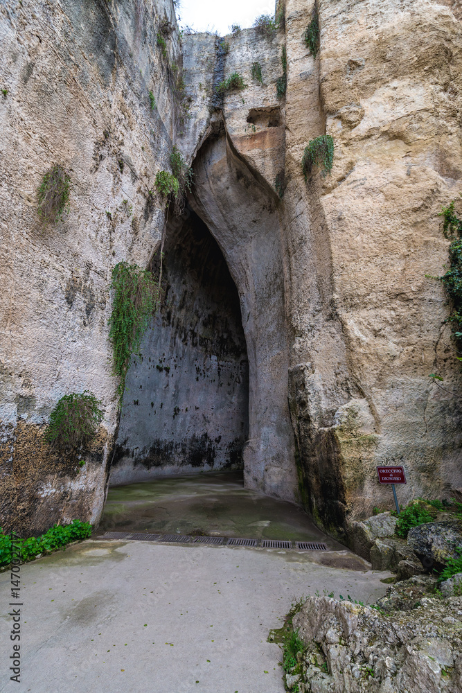 Entry to cave called Ear of Dionysius in ancient quarry, Neapolis Archaeological Park in Syracuse, Sicily Island of Italy