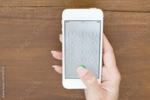 Wallpaper Mural Flat lay hand using phone Torontodigital.ca