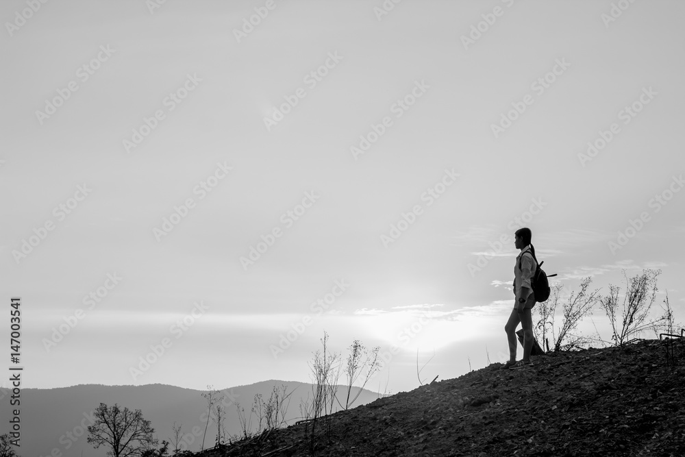 Woman backpacking to watch the sunset