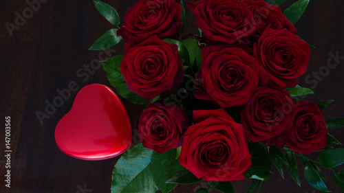 Closeup of a rose bouquet with a heart-shaped chocolate box