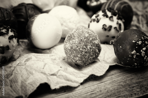 Selection of delicious chocolates on a rustic background