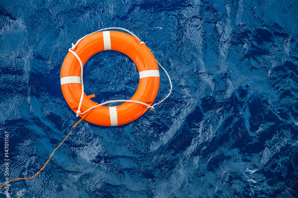Fototapeta premium Safety equipment, Life buoy or rescue buoy floating on sea to rescue people from drowning man.