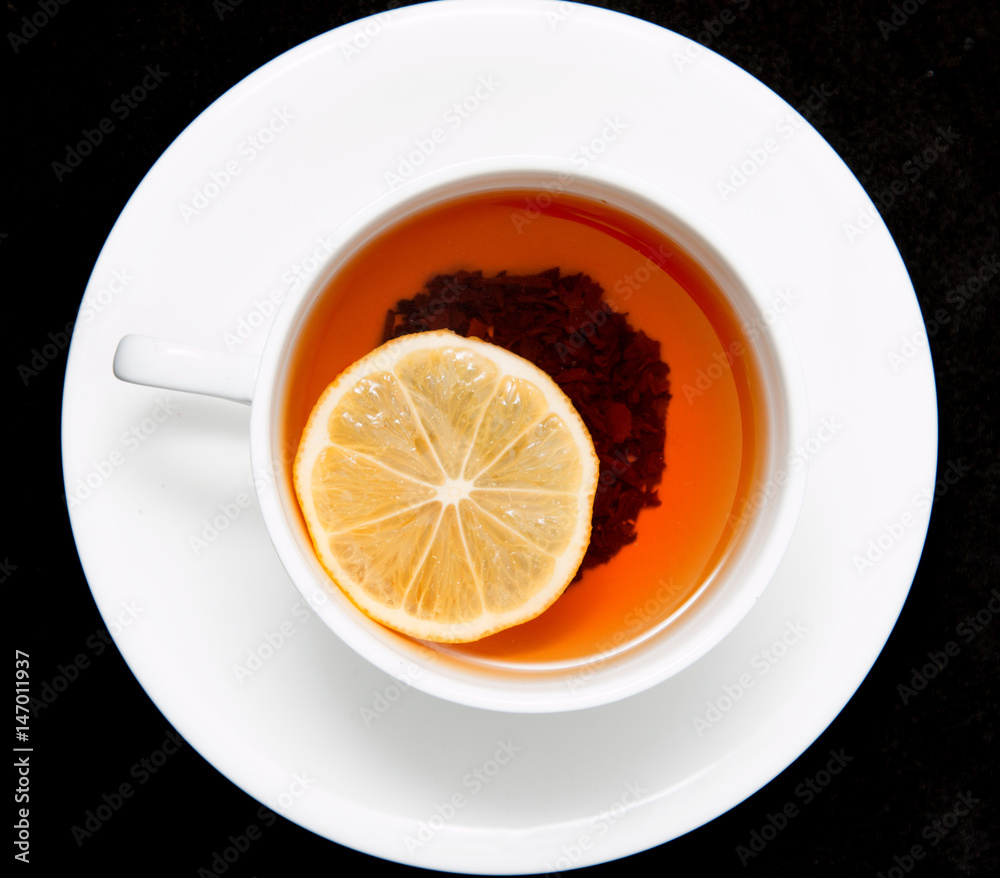 tea with lemon on a black background tea with lemon on a black background
