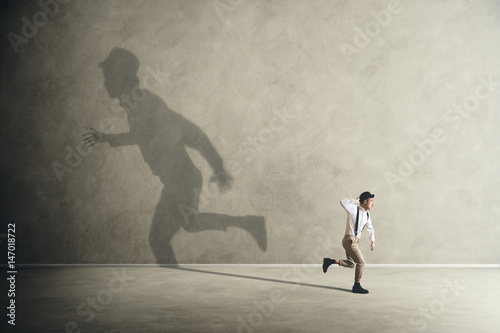 man and his shadows running in different direction photo