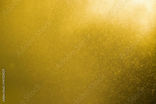 abstract of gold light particle and glitter bokeh. image is blurred