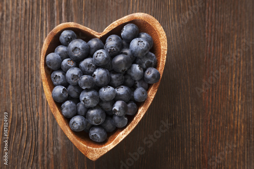 ripe sweet blueberries on wooden table