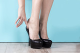 Woman dresses black high-heeled shoes