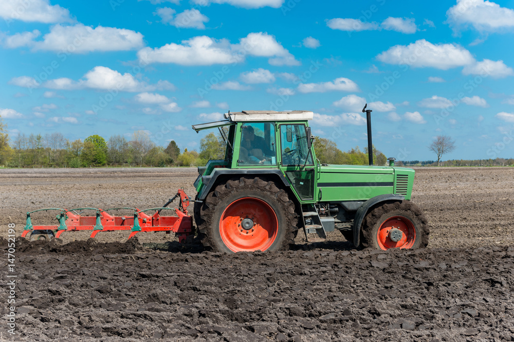 Old tractor with a 4 coulter plow on the field - 7308 Old tractor with a 4 coulter plow on the field - 7308