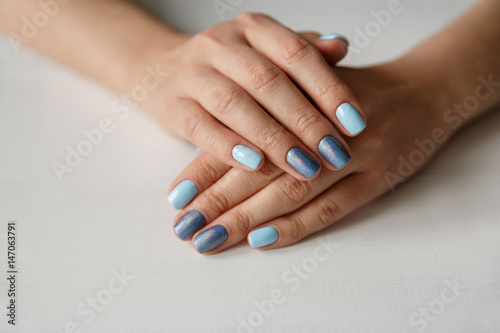 Natural nails with beautiful manicure  blue polish on women nails