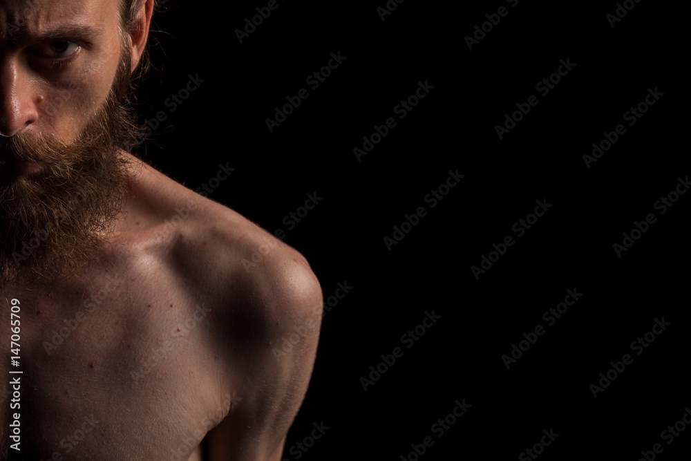 Portrait of bearded cool hipster on black background in studio photo. Expression and fashion