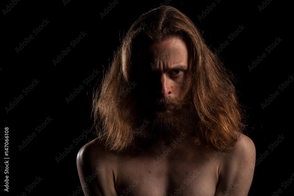 Hipster with long hair and beard on black backgroundin studio photo. Expression and fashion Hipster with long hair and beard on black backgroundin studio photo. Expression and fashion