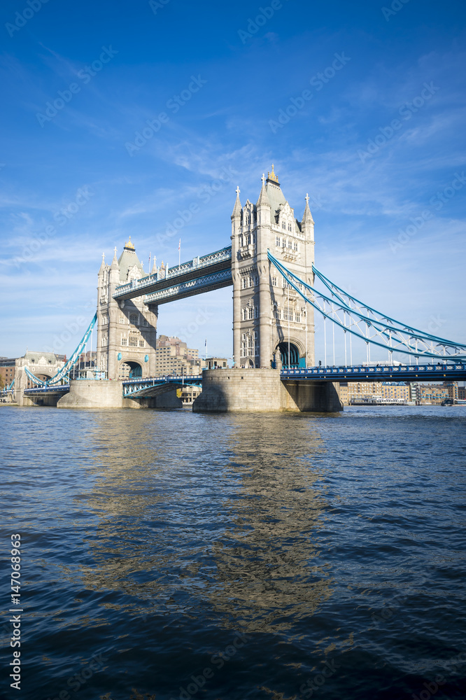 Bright scenic view of Tower Bridge standing in blue sky above the River Thames in London, UK
