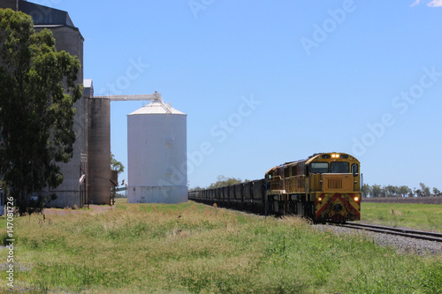 Railway line with coal train and silos
