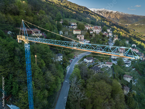 Aerial view of construction site crane in alpine valley in Switzerland