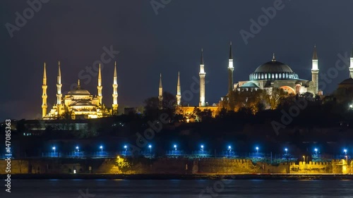 Hagia Sophia and Blue Mosque timelapse at night reflected in Bosphorus water. Istanbul, Turkey photo