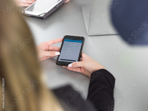 Elegant Woman Using Mobile Phone in office building