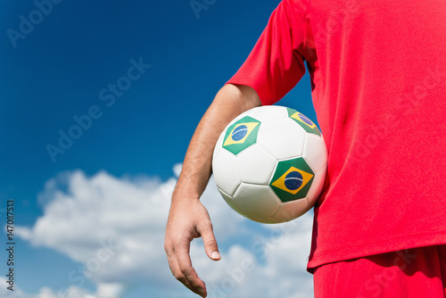 Soccer player holding Brazil ball