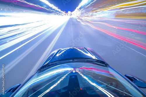 Photography View from roof of Car moving in a night city, Blured road with lights with car on high speed