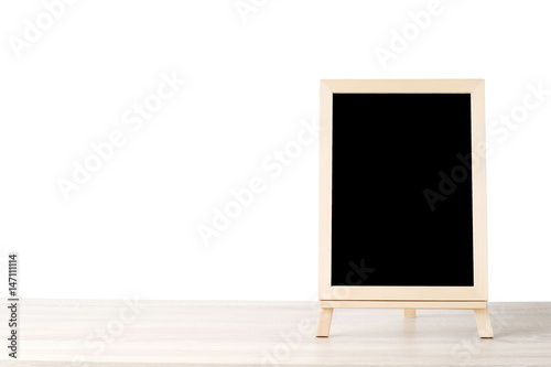 Blank chalkboard standing on wood table isolated on white background, space for text, mock up, product display montage, banner