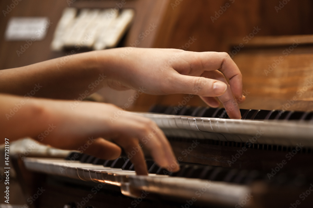 Hands of a woman playing the organ Hands of a woman playing the organ