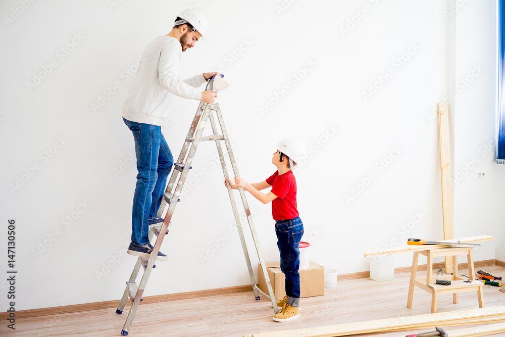 Father and son working together Father and son working together