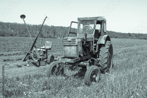 Old tractor sitting in a field