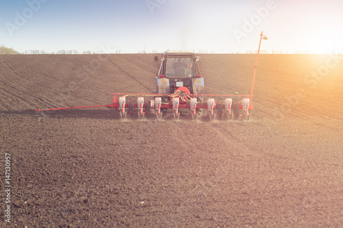 silhouette Farmer in tractor preparing land with seedbed cultivator over Blurred construction site.CSR ESG Business on industry, People, Science,Signs, Symbols, Technology, Transportation concept photo