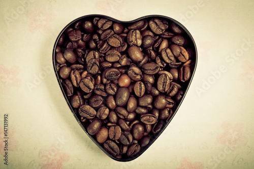 shape of a heart filled with coffee beans over romantic backround © starblue