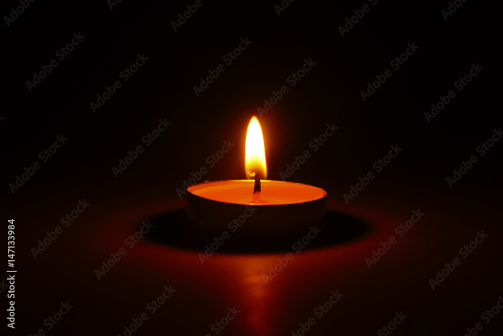 The light of burning candle in the dark The light of burning candle in the dark