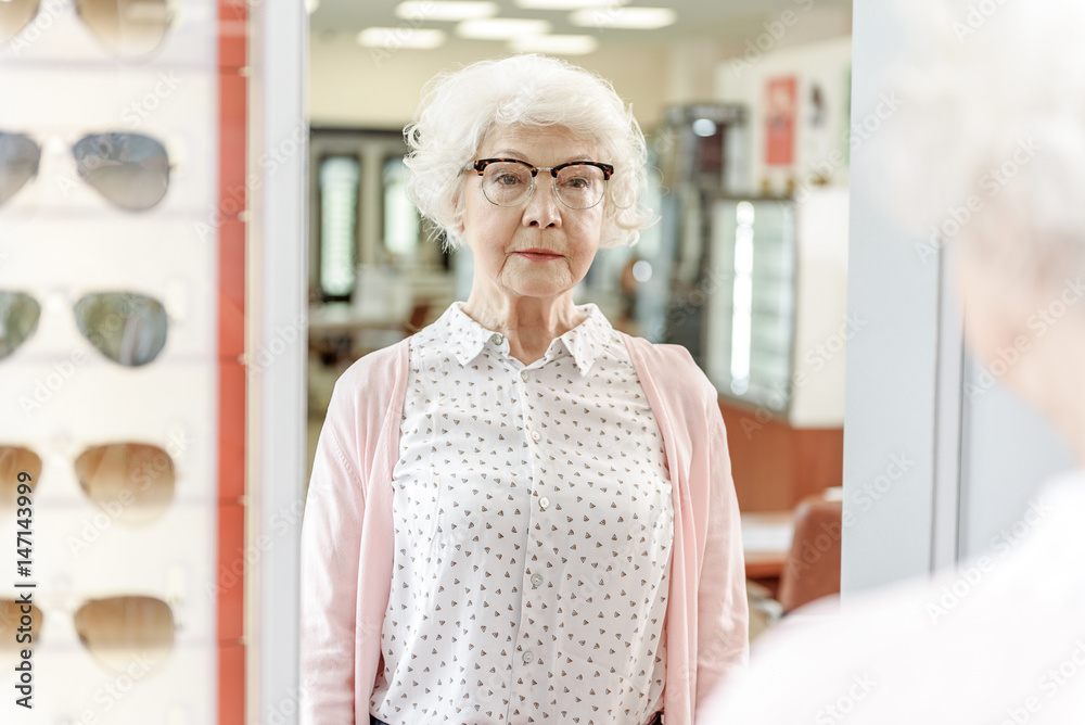 Old woman glancing at mirror Old woman glancing at mirror