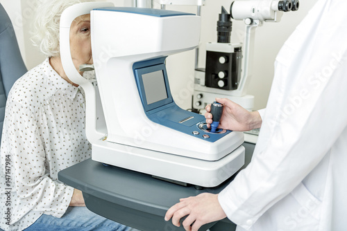 Old female patient in cabinet of doctor photo