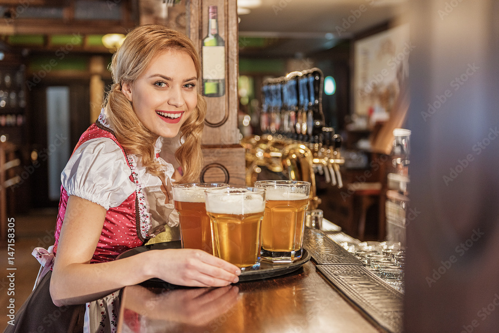 Happy young waitress carrying beverage Happy young waitress carrying beverage