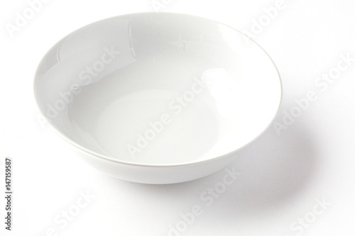 White wide salad bowl from side on a white background