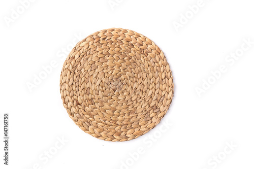 Light brown/beige round place mat on a white background
