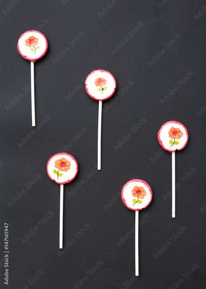 Lollipops sweets. Candy, top view flat lay on black background. Sweet sucker, lollipop, candy, food background Lollipops sweets. Candy, top view flat lay on black background. Sweet sucker, lollipop, candy, food background
