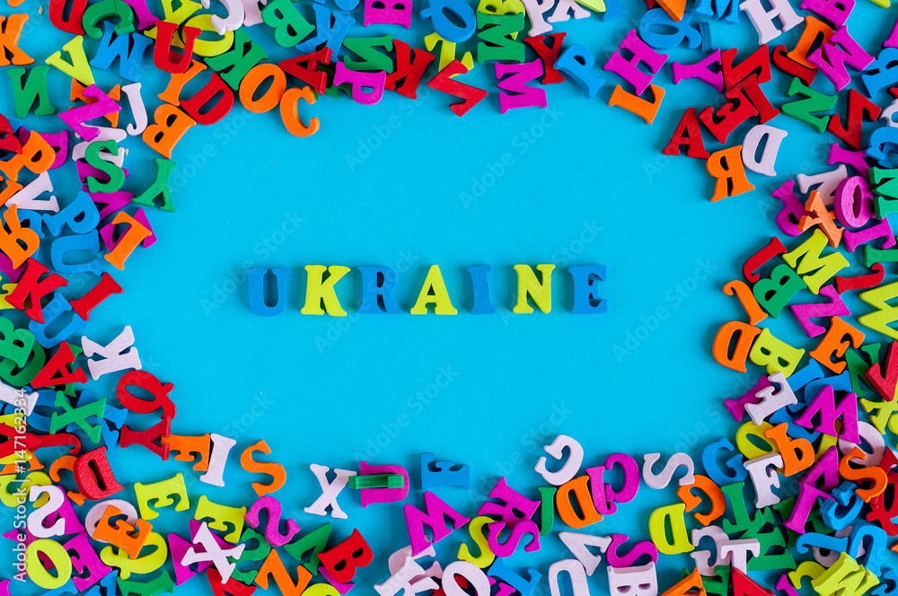 UKRAINE - word composed of small colored letters on blue background fith frame of many little letter. 2017 year