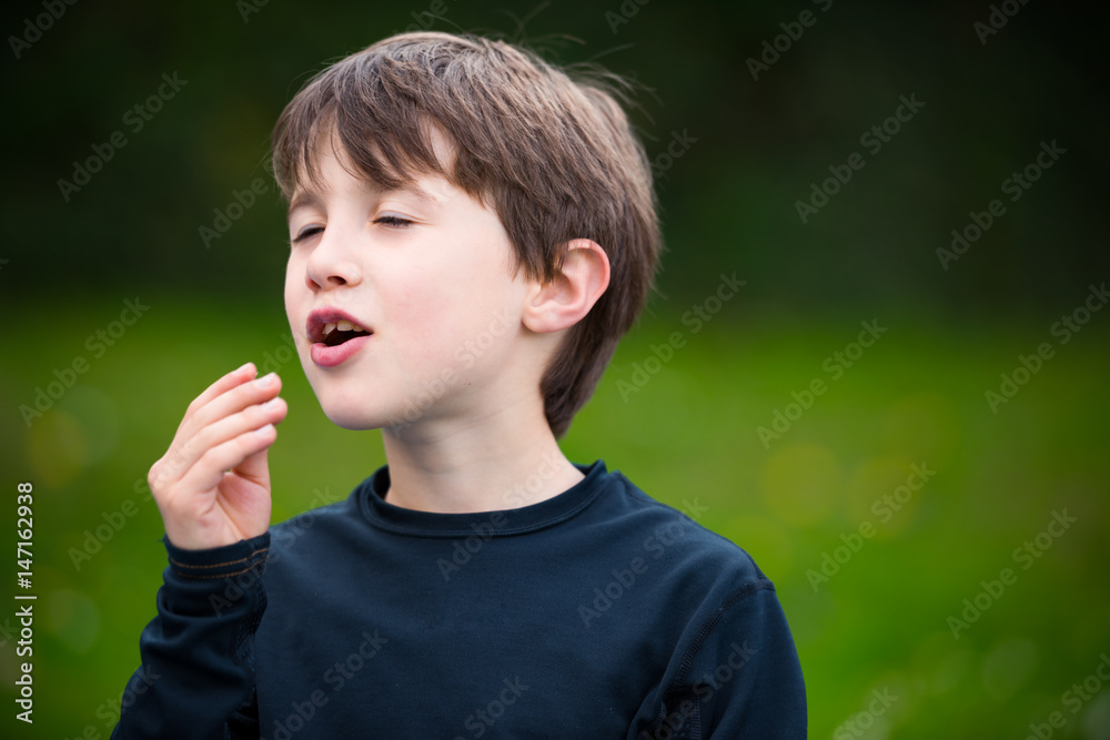 Cute boy savoring crisps Cute boy savoring crisps