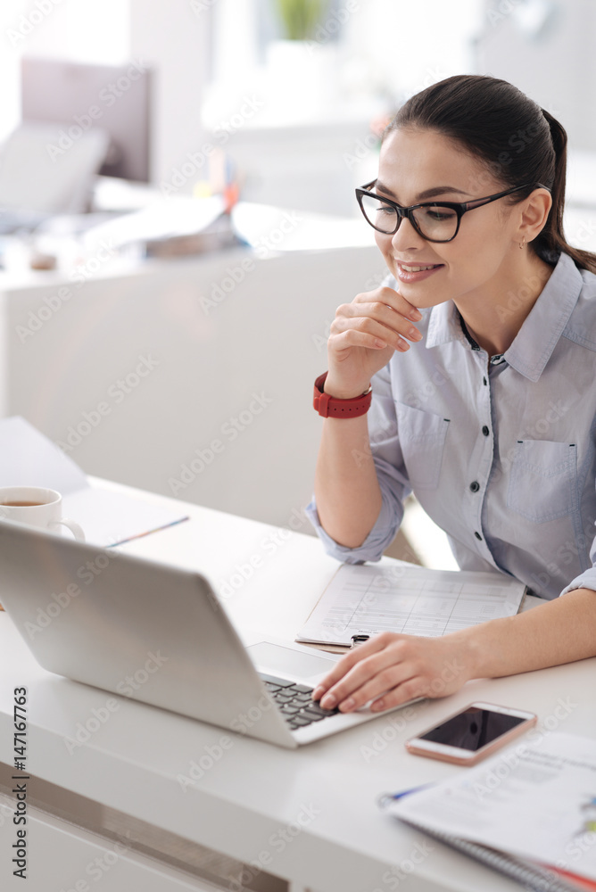 Vertical photo of concentrated female being in the office Vertical photo of concentrated female being in the office