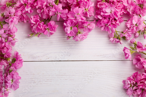 Pink flowers on wooden background